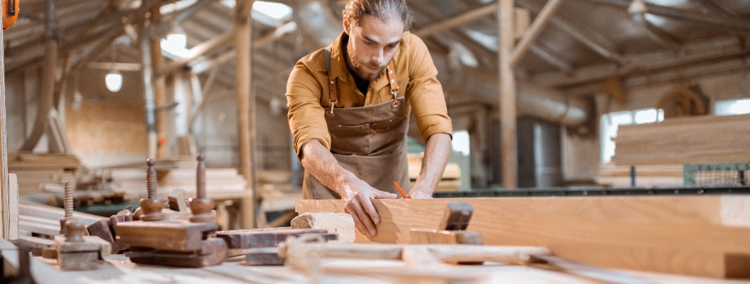 Carpenter working with a wood in the workshop