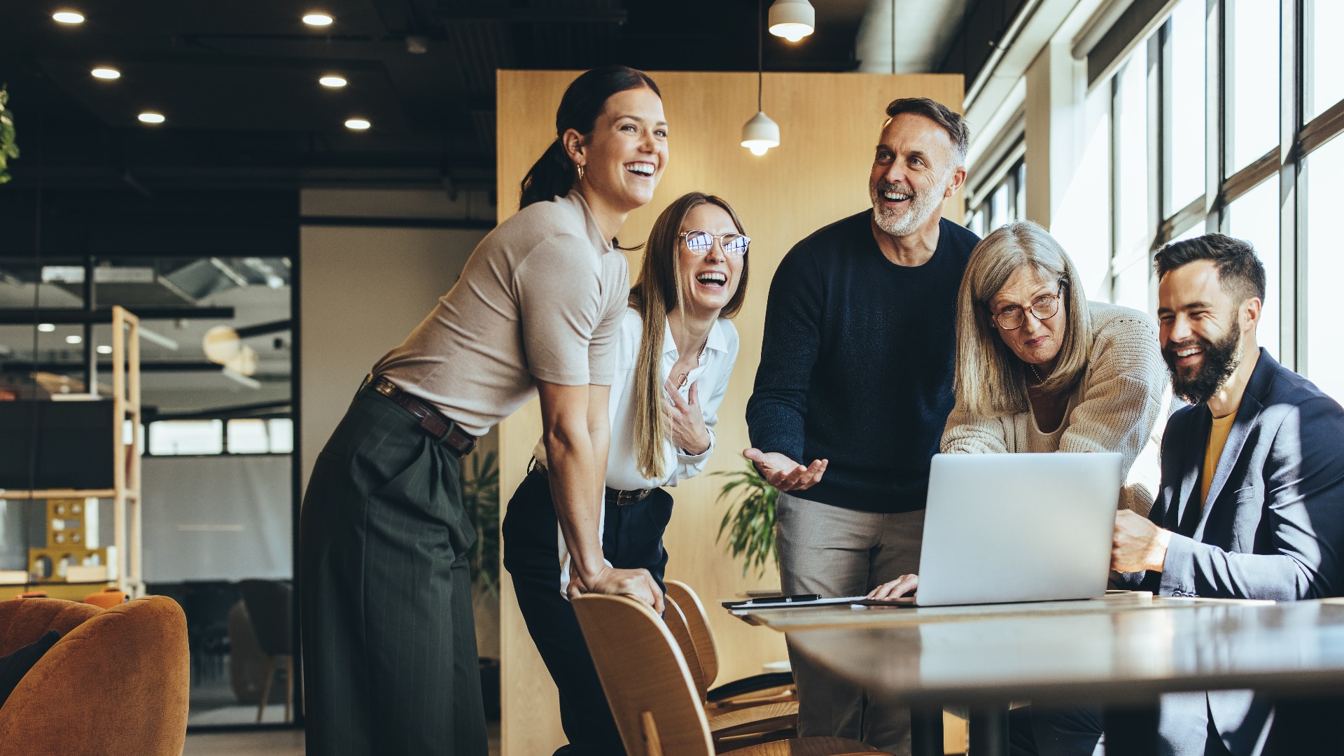 Happy businesspeople laughing in an office